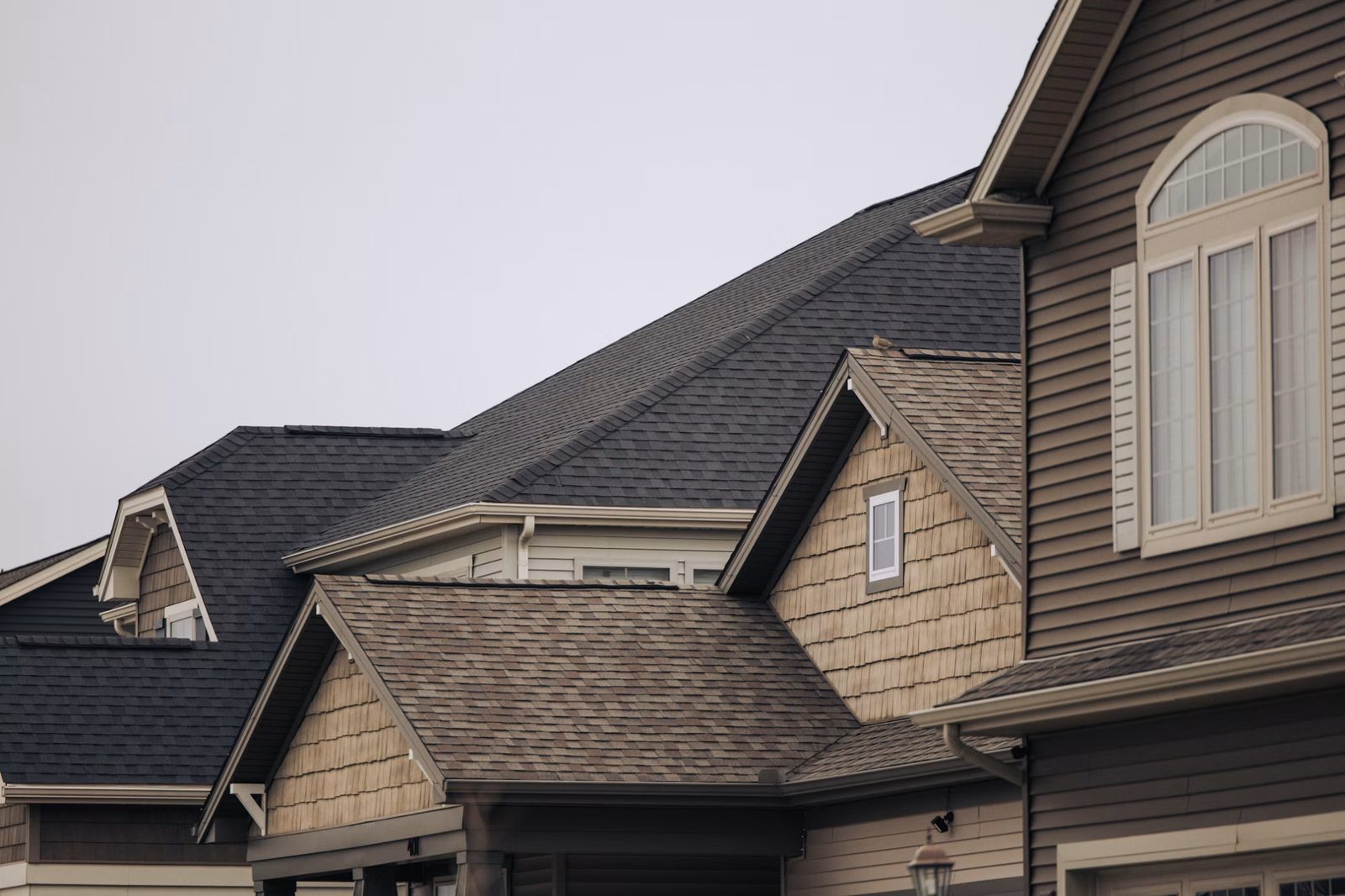 Row of house with brown shingles and white windows