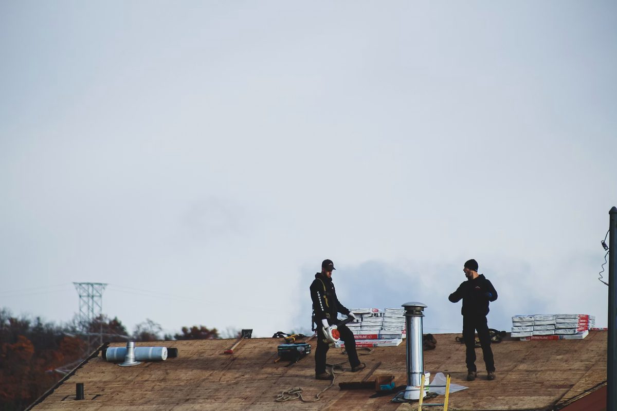 Workers inspecting a roof
