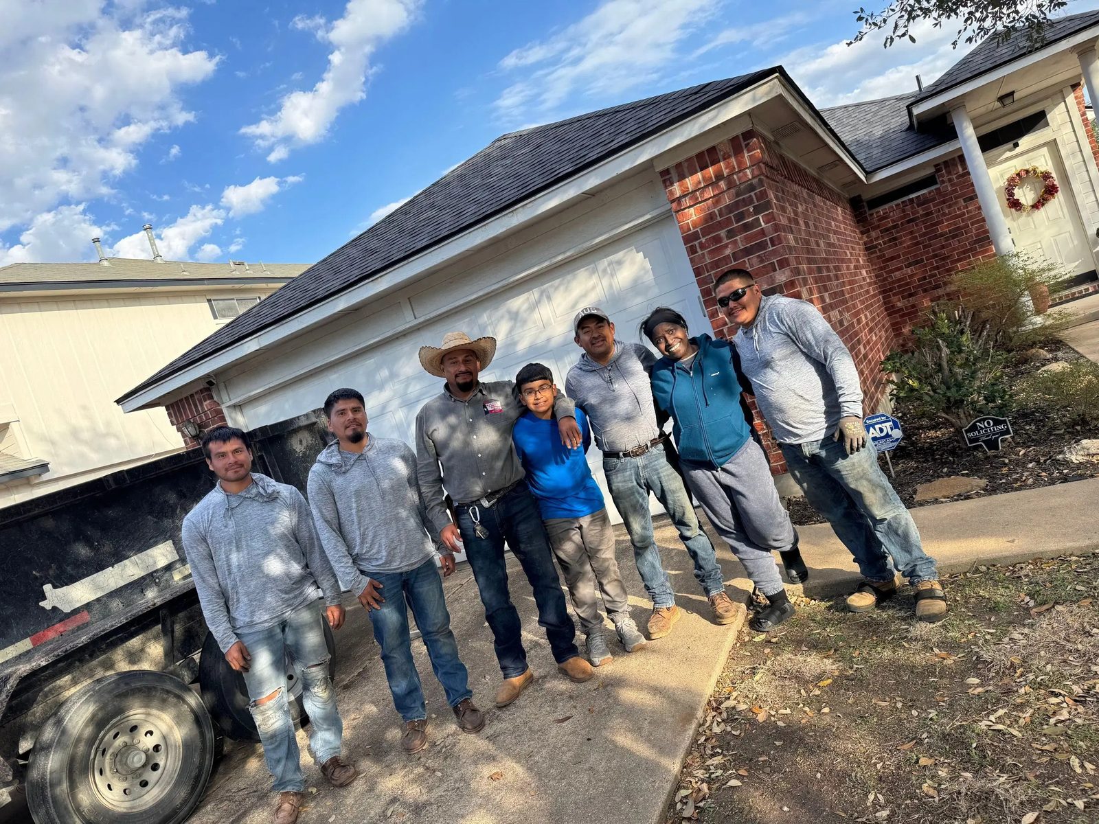 The REPS Austin Area Roofers crew standing in front of a project site, showcasing the team that performs all work without subcontractors
