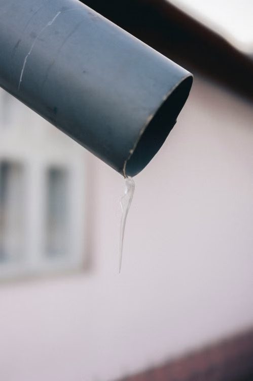 Water dripping from metal gutter